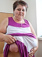 Old fat slut with gigantomastia gets naked