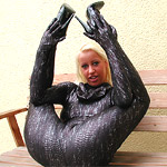 Two rubber dominas whipping bondaged latex slave girl in the dungeon
