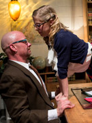 Enslaved dude in rubber uniform gets his first anal experience with straponed gf.