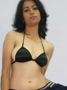 Young indian girl in stockings toying on sofa