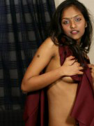 Young indian girl undressing and fingering on bed