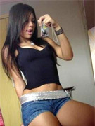 Perscilla gets all wet while she washes a car
