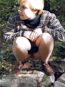Hot young ho pees over a dirty gutter in the park