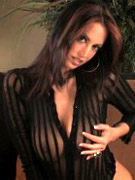 Beautiful busty brunette, nikki nova, puts on a sexy striptease and peels out of her see through black top and sheer black panties to reveal her amazi