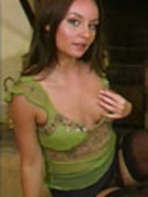 "video of carla in a sheer green top[] black miniskirt and stockings."