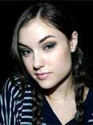 Sasha grey restrained in a tight straitjacket and leather straps.