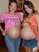 Sexy pregnant chick in knee high black boots strips nude.