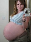 Preggo chick in a wet nylon body suit.