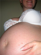 Sexy preggo chick gets naked in her bathroom.