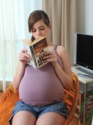 Beautiful pregnant lady with small titties and big swollen belly gets naked on cam