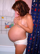 Busty preggo in white lingerie gets her holes double plugged with strapon and dildo.