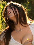 Perfect melons teen beauty teasingly pulls down her white panty while posing topless on the table.