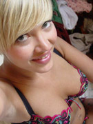 Gorgeous blonde undresses out of her military uniform.