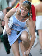Perfect body brunette college girl in kneesocks sedcutively posing on the sofs.