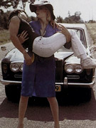 Gymnastic seventies couple doing it on all outdoor on a bike