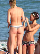 Hot girls in tiny bathing suites at the beach oiling up