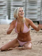 Nude teasing blonde deepthroats a guy on the beach